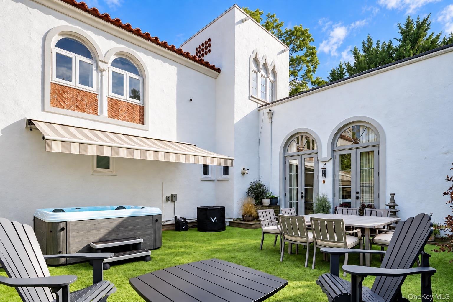 Courtyard with turf and retractable awning