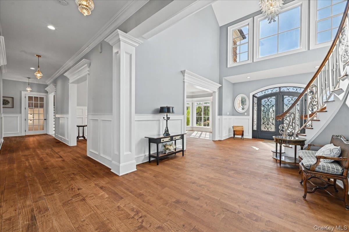 Wood-finish flooring throughout, with wainscoting and crown molding details