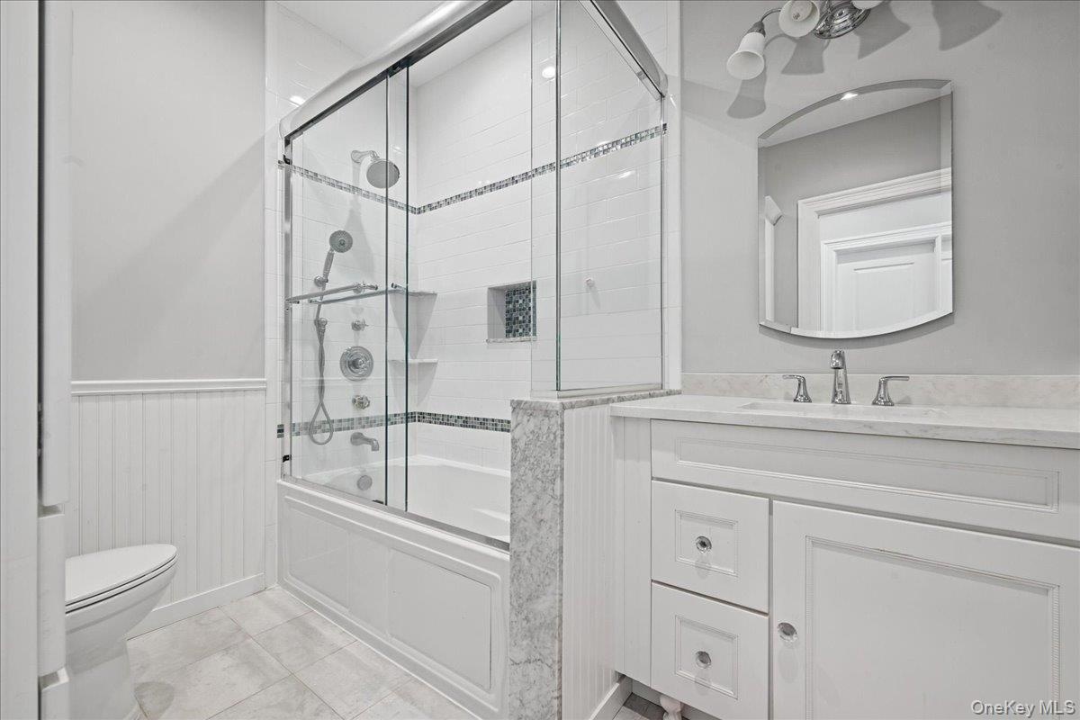 White vanity with a single basin sink and polished chrome faucet