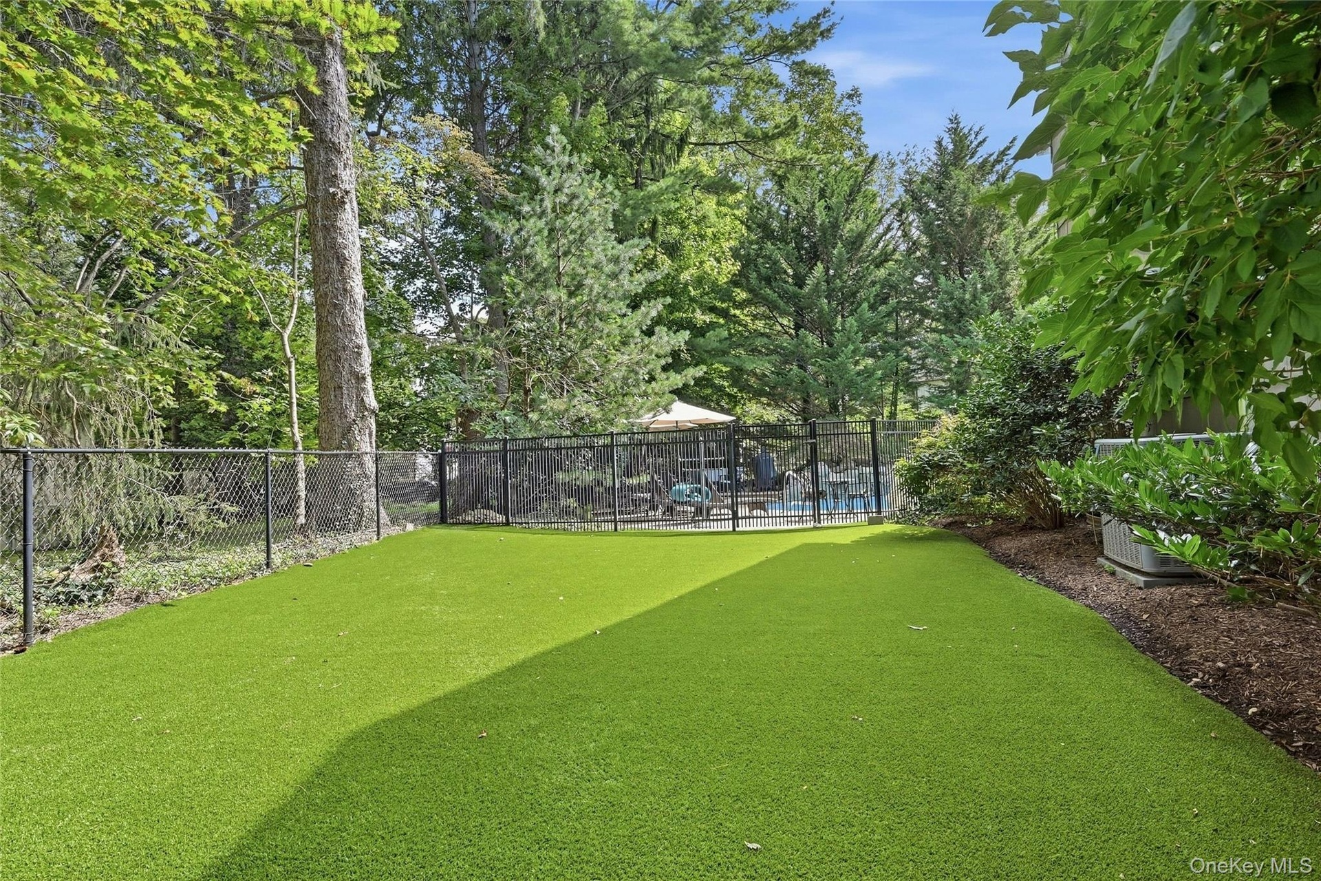 Turf fenced dog run