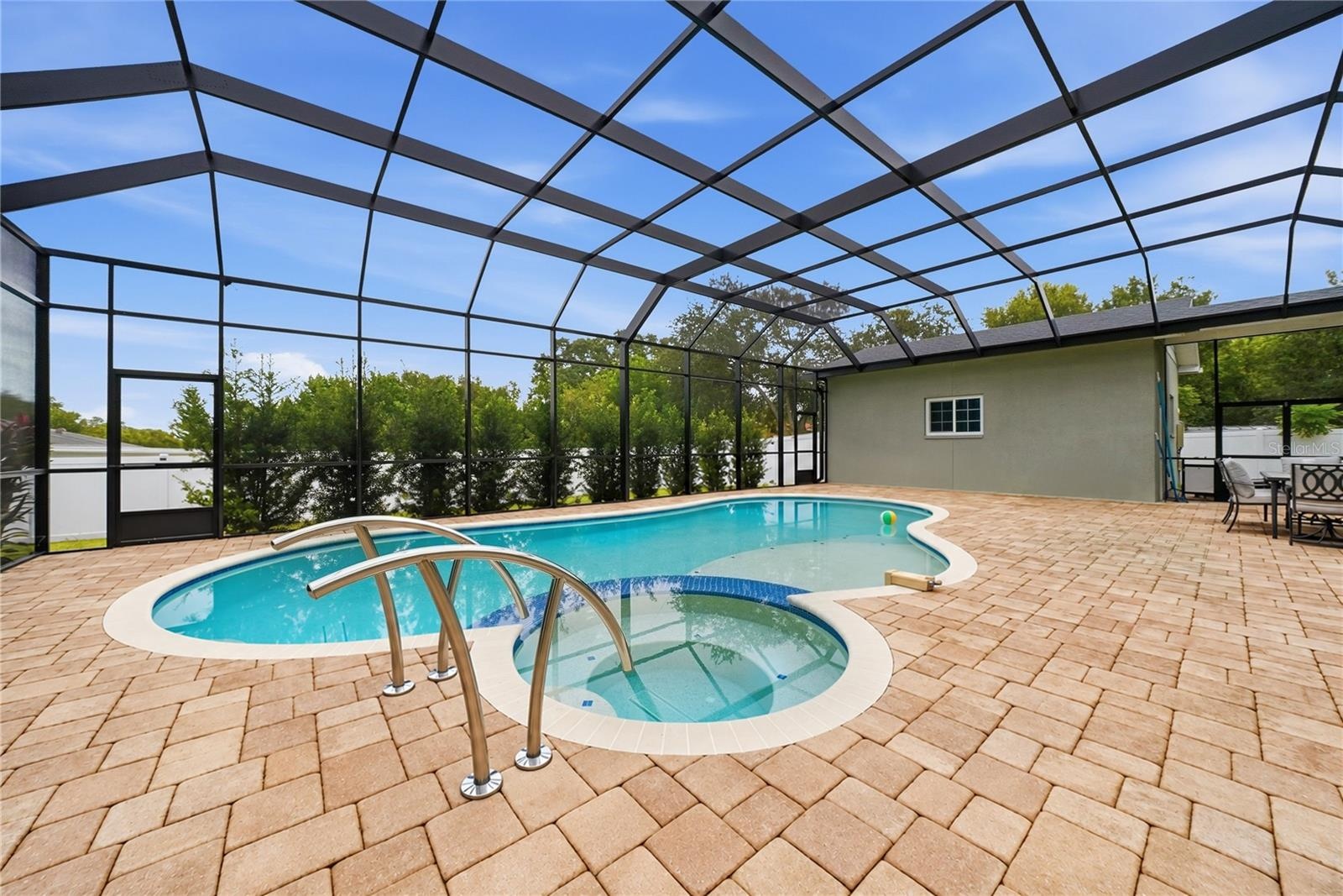 Screened pool with stunning paver deck