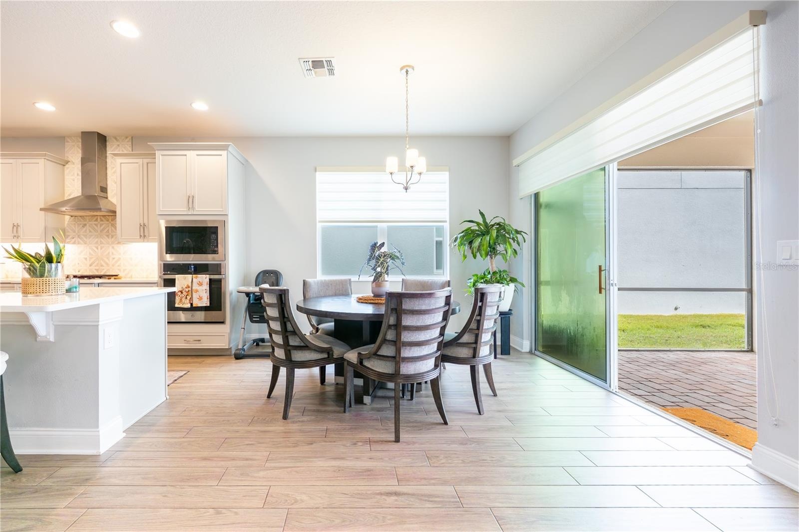 Inviting breakfast nook beside the kitchen, with sliding glass doors opening to the covered patio.