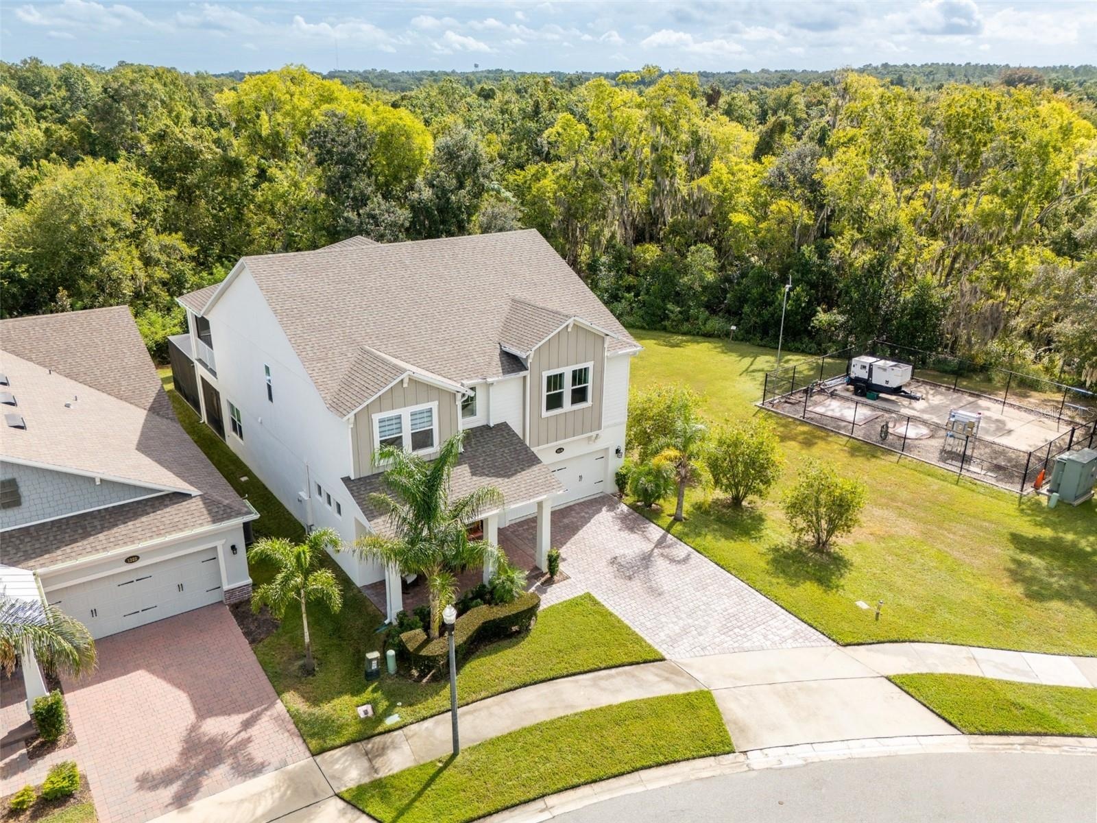 Aerial view showcasing conservation surroundings with no rear neighbors or neighboring home on the right.