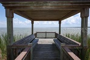 Covered lakeside gazebo, ideal for enjoying sunrises and capturing beautiful photos.