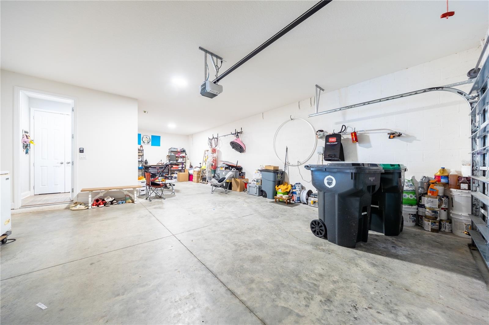 Spacious garage with direct home access and additional room for storage or a workshop.