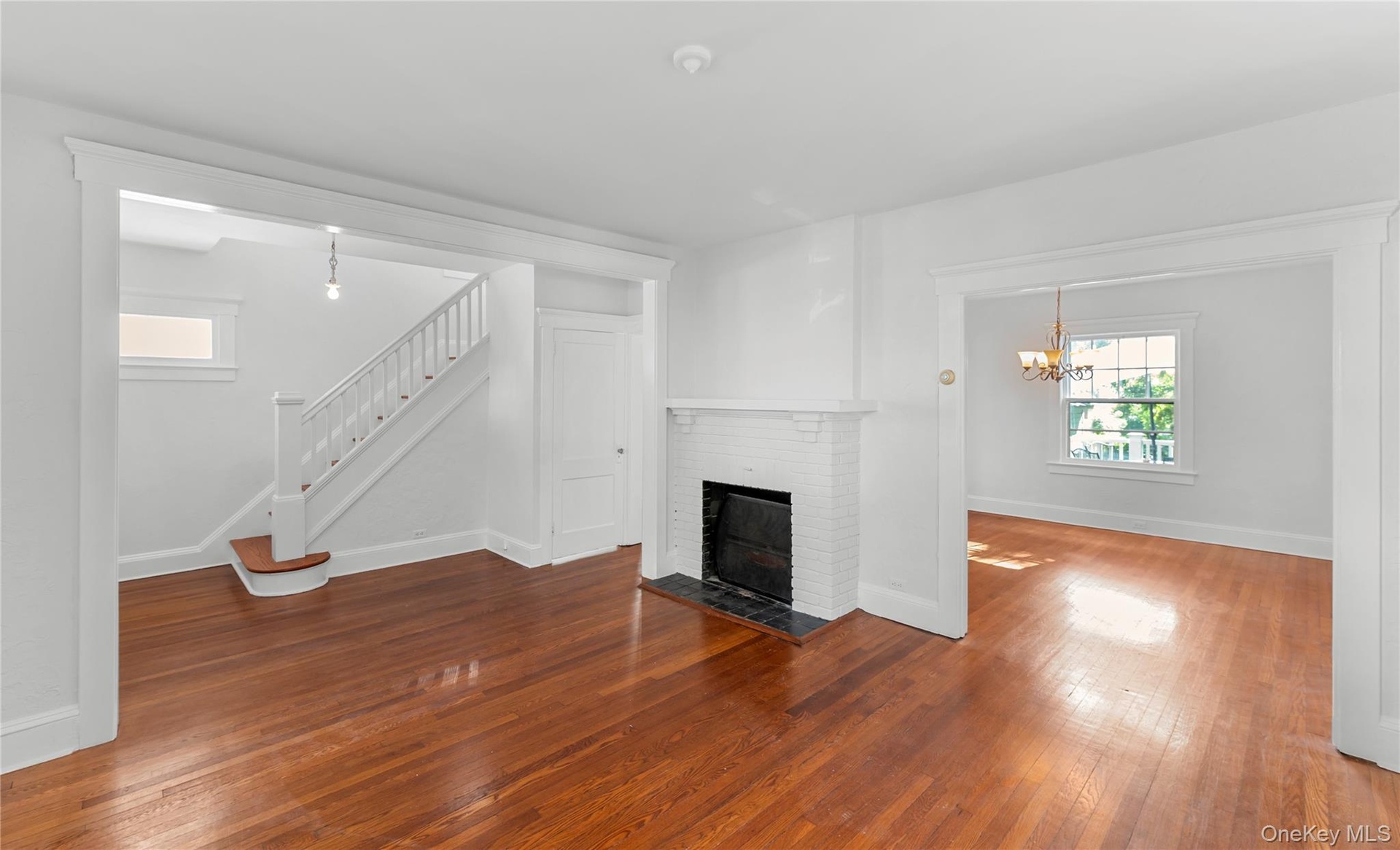 spacious living room to dining room with fireplace. Side hall style