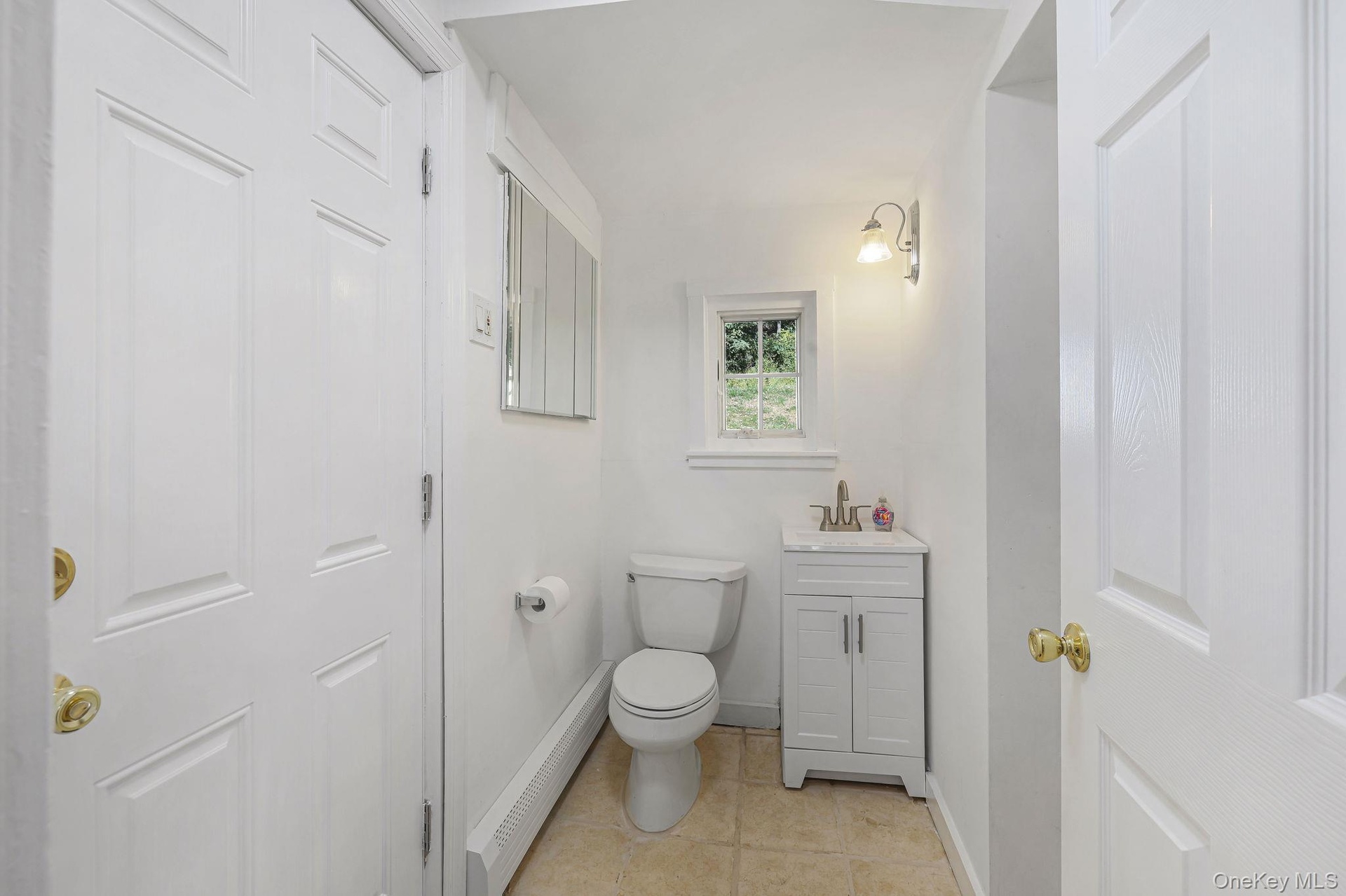 Main level powder room leading to the Laundry Room