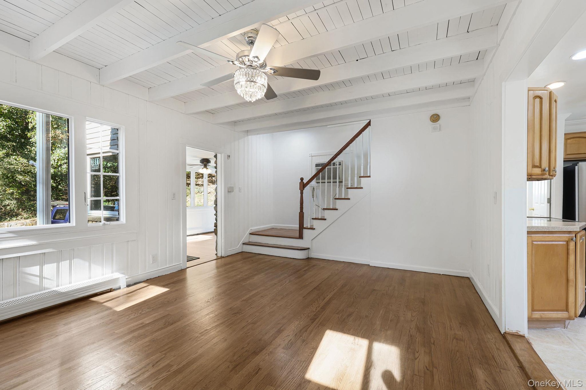 Living room with Chandelier Fan and Stair Case Leading to 2nd Floor