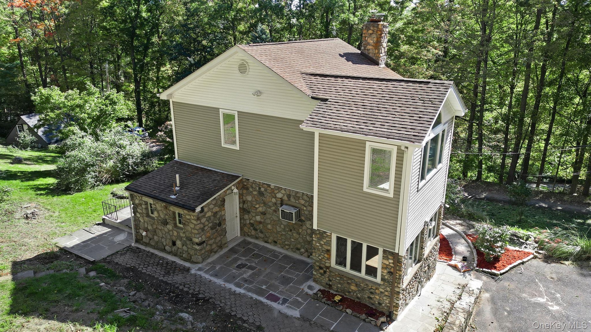 Home surrounded by Stone/Concrete steps and entry access to the Property