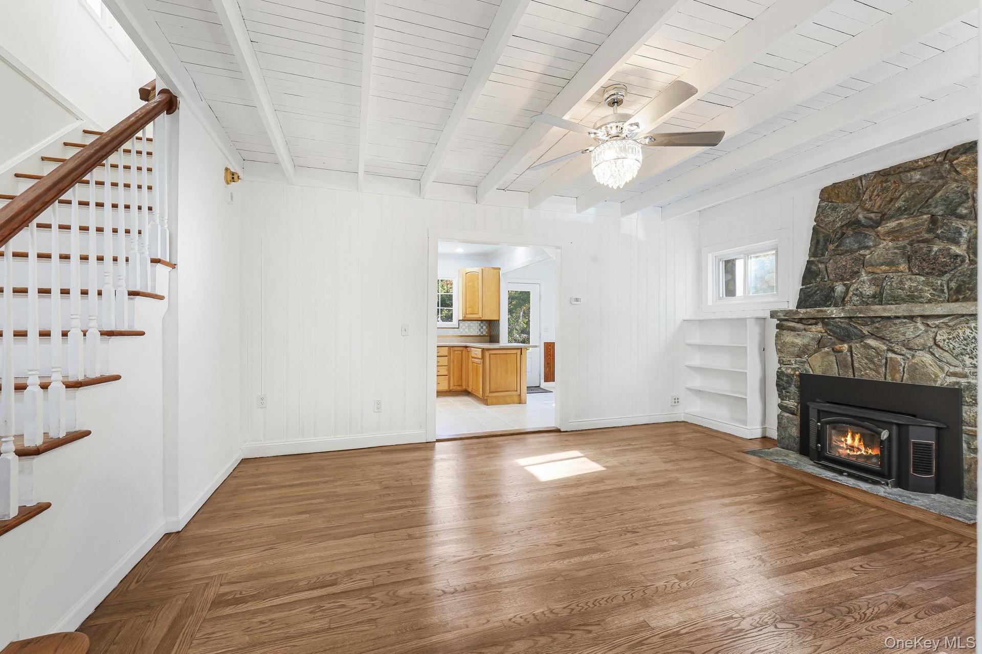Spacious Living room with beautiful Hardwood floors and stunning Fireplace.