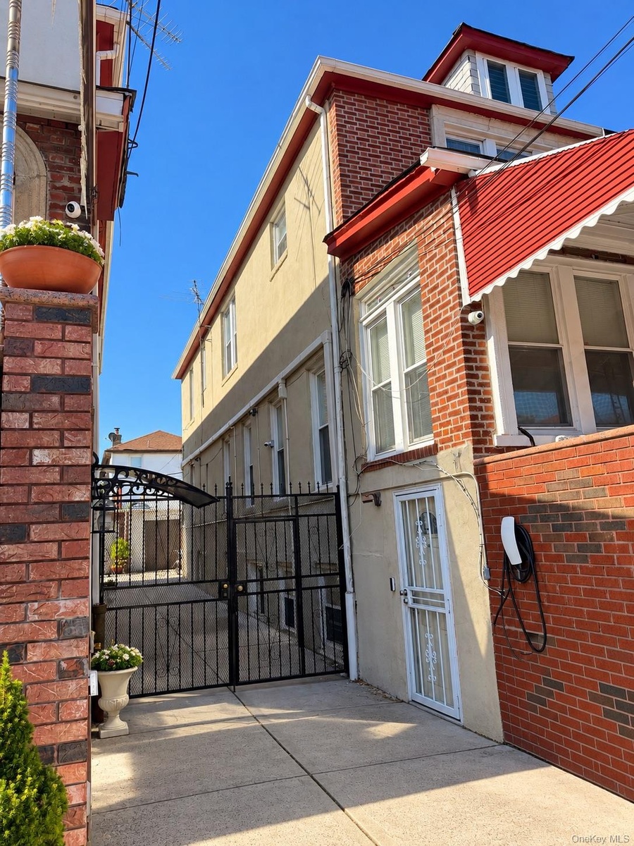 Brick and stucco facade with a red awning