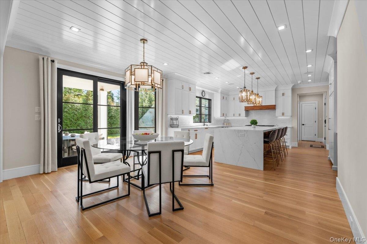 Breakfast area with open concept looking into kitchen and back patio.