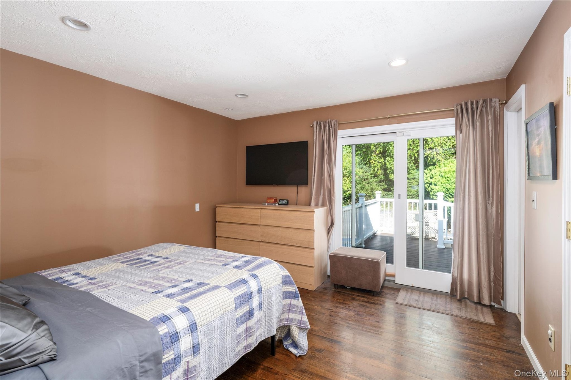 Main floor primary bedroom with walkout to deck.
