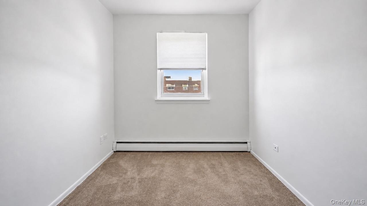 Recessed window with a white frame, neutral carpet, and white walls