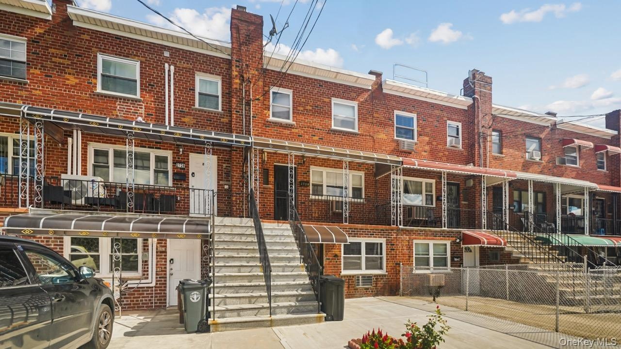 Brick facade with white trim windows and a covered entry