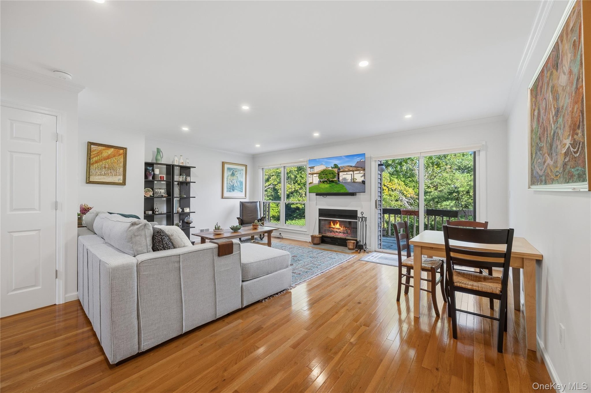 Living Room with wood burning Fireplace and sliding glass door to wood deck
