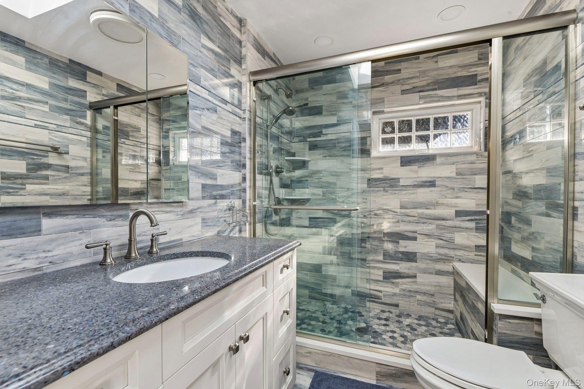 Walk-in shower with seat.