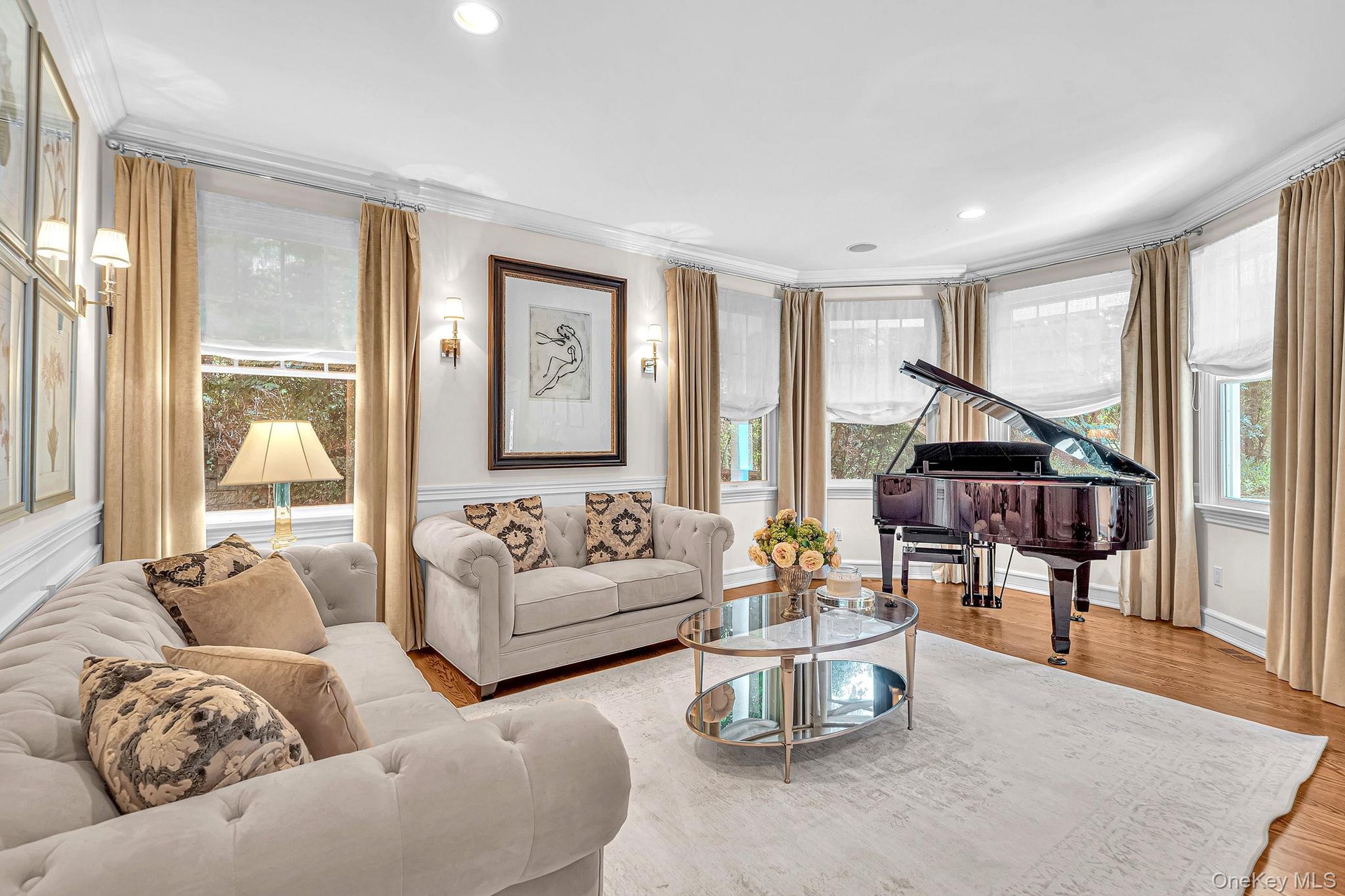 Recessed lighting, crown molding, wood-finish flooring, multiple windows, and wall sconces