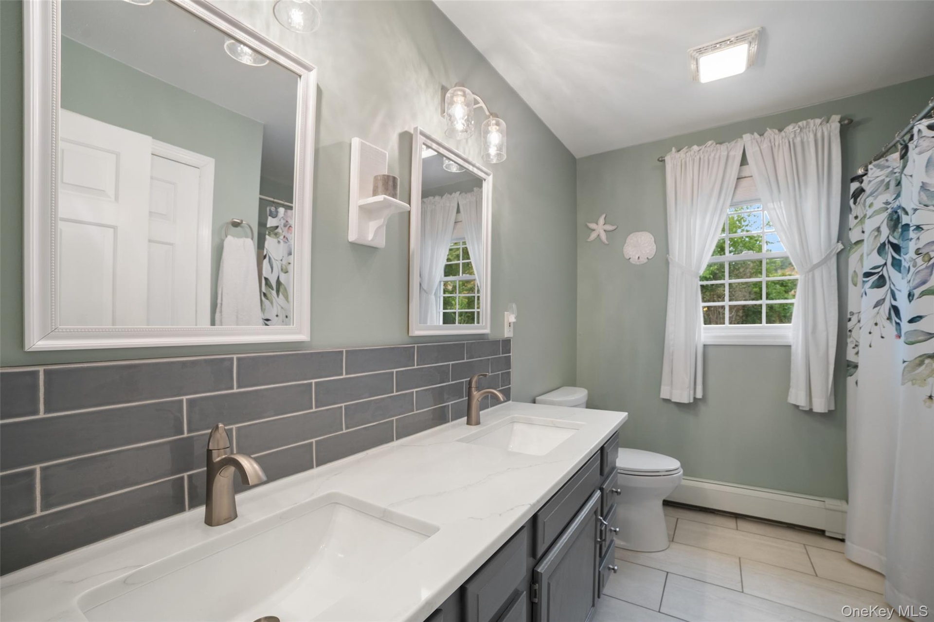 Bathroom with double sinks and tub