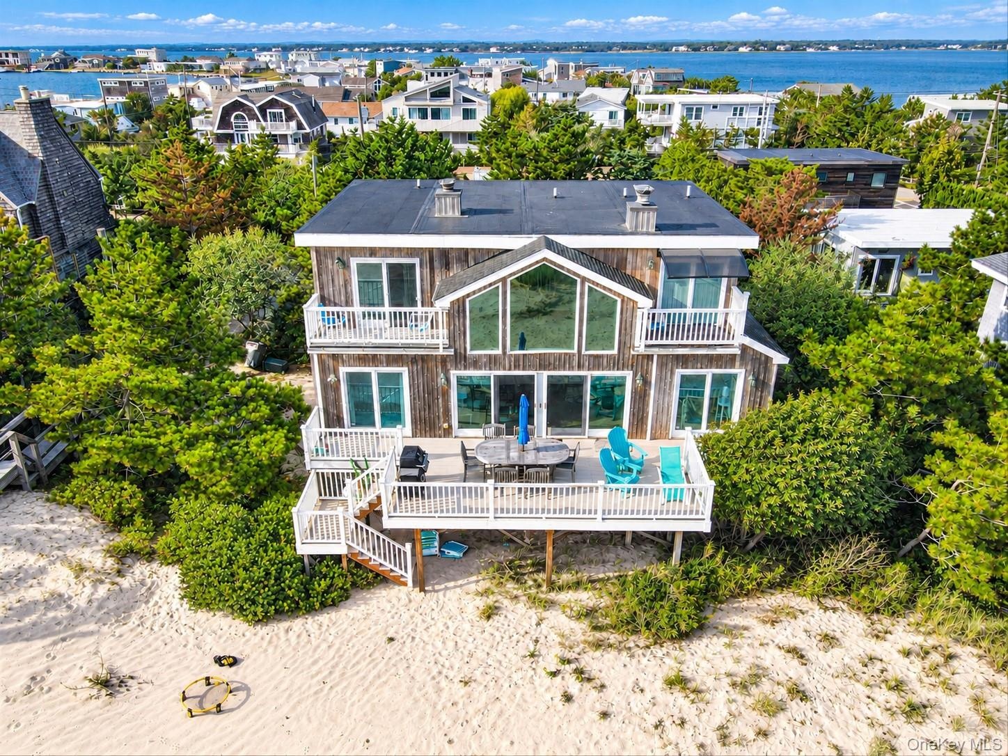 Wood-sided residence with multiple balconies and a spacious exterior deck