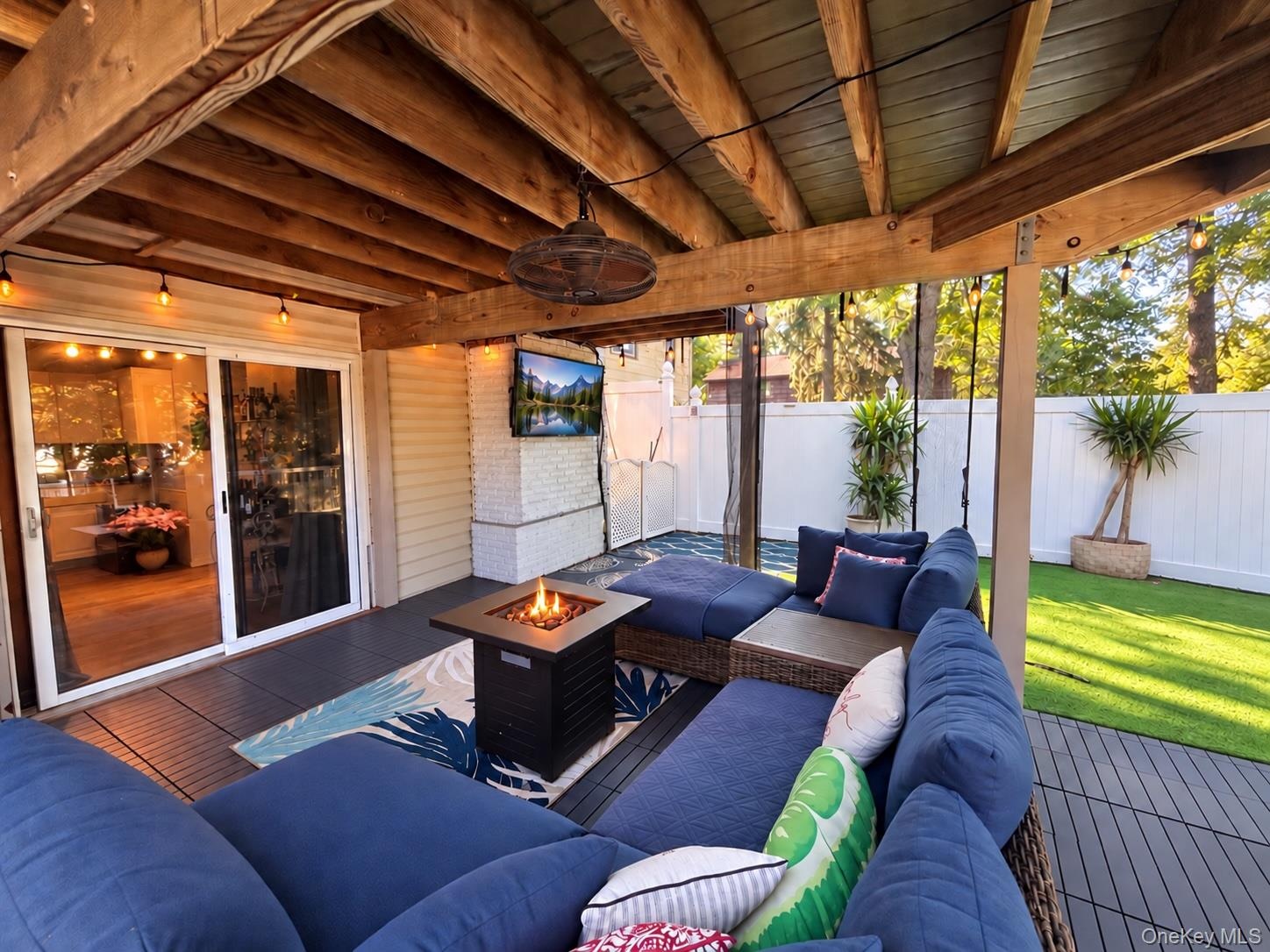 Covered porch with TV and fire pit