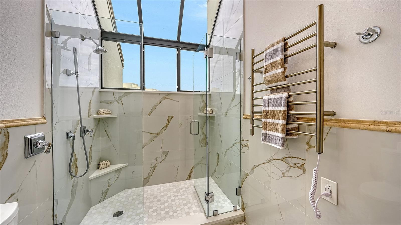 THE TOWEL WARMER W/ THE GARDEN WINDOW IN THE PRIMARY BATHROOM