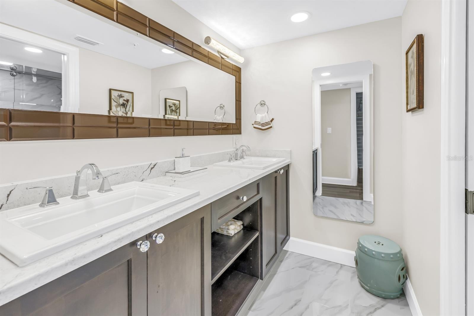 Primary En-Suite Features Quartz and Glass Enclosed Shower