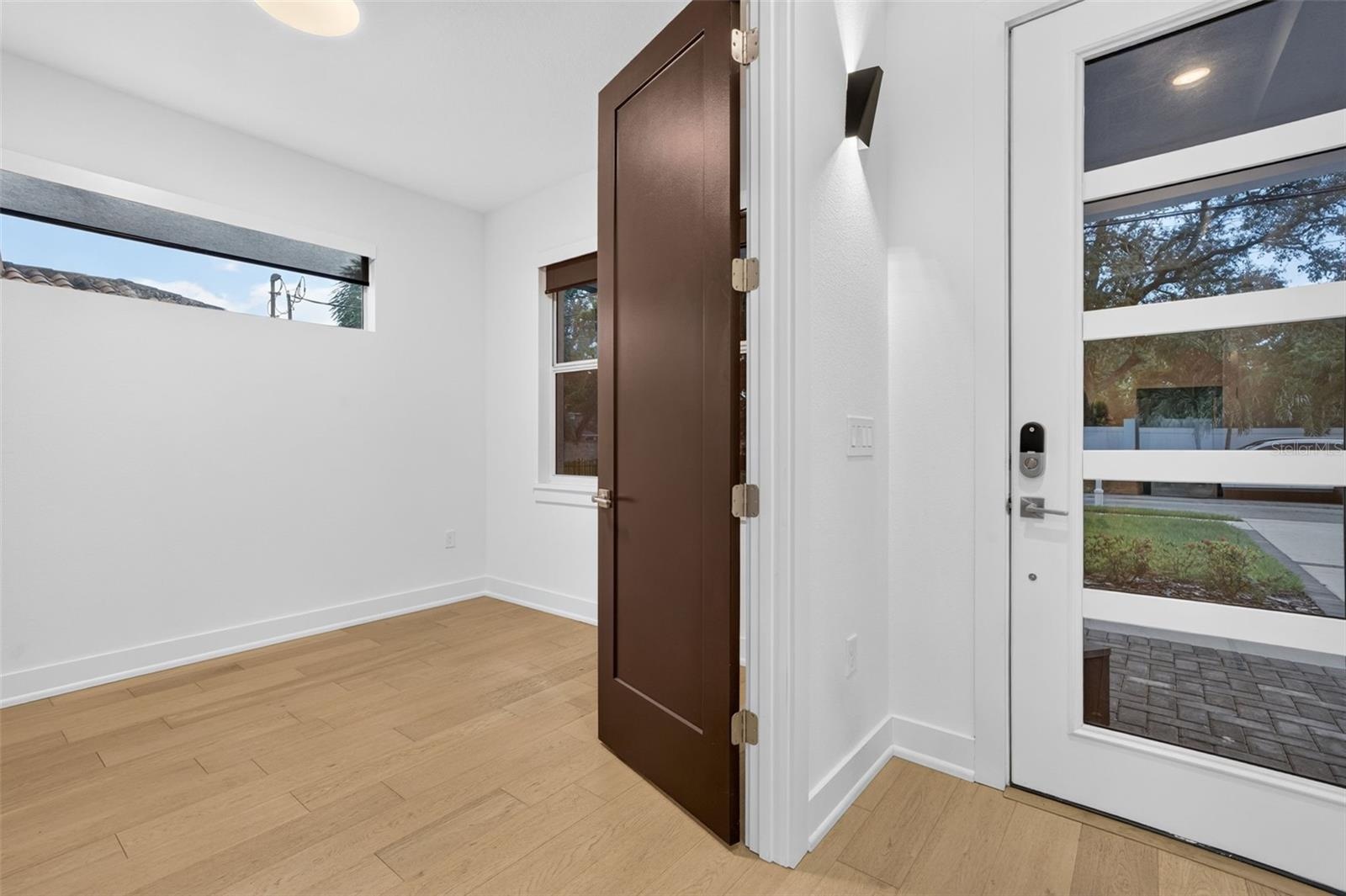 Foyer and large office-den-5th bedroom-double wood doors.