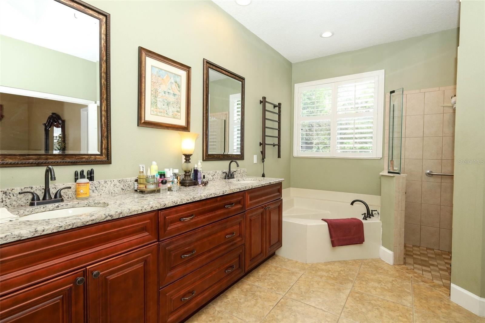 Owners en-suite bathroom with garden tub, new vanity, granite counters and walk-in shower