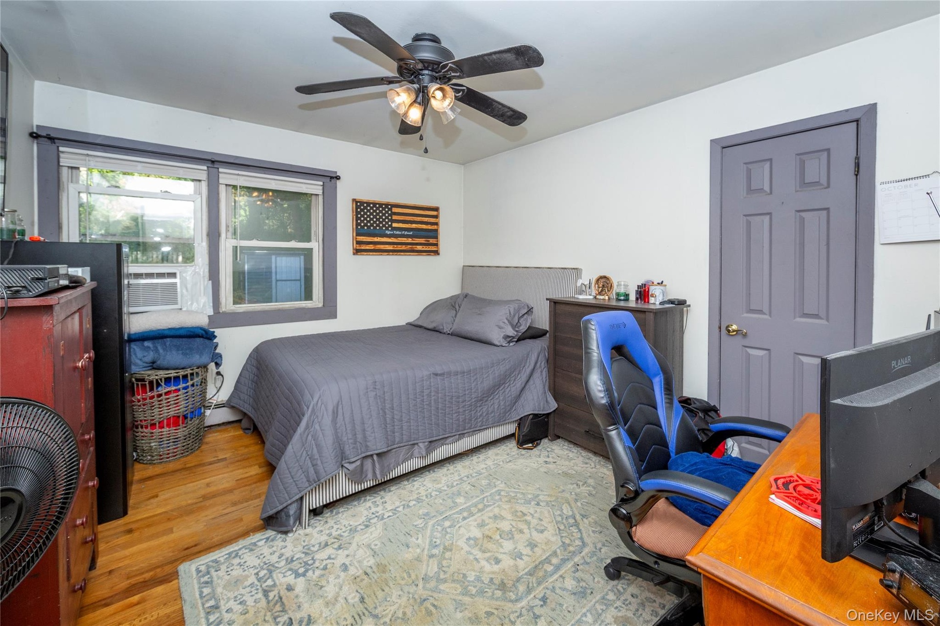 The main floor boasts five versatile bedrooms. The current setup utilizes three as dedicated bedrooms. View of one of the bedrooms.