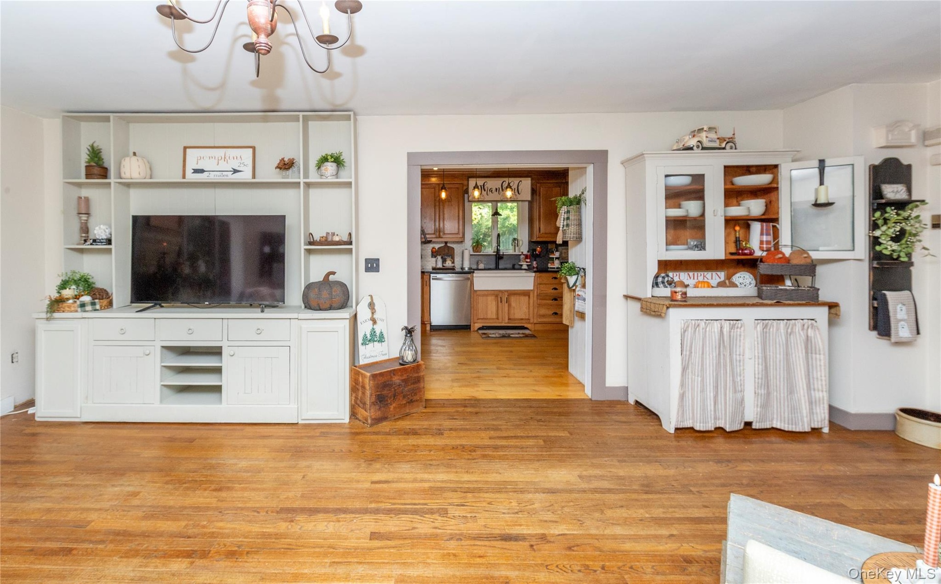 A wide opening from the living room flows naturally into the country kitchen.