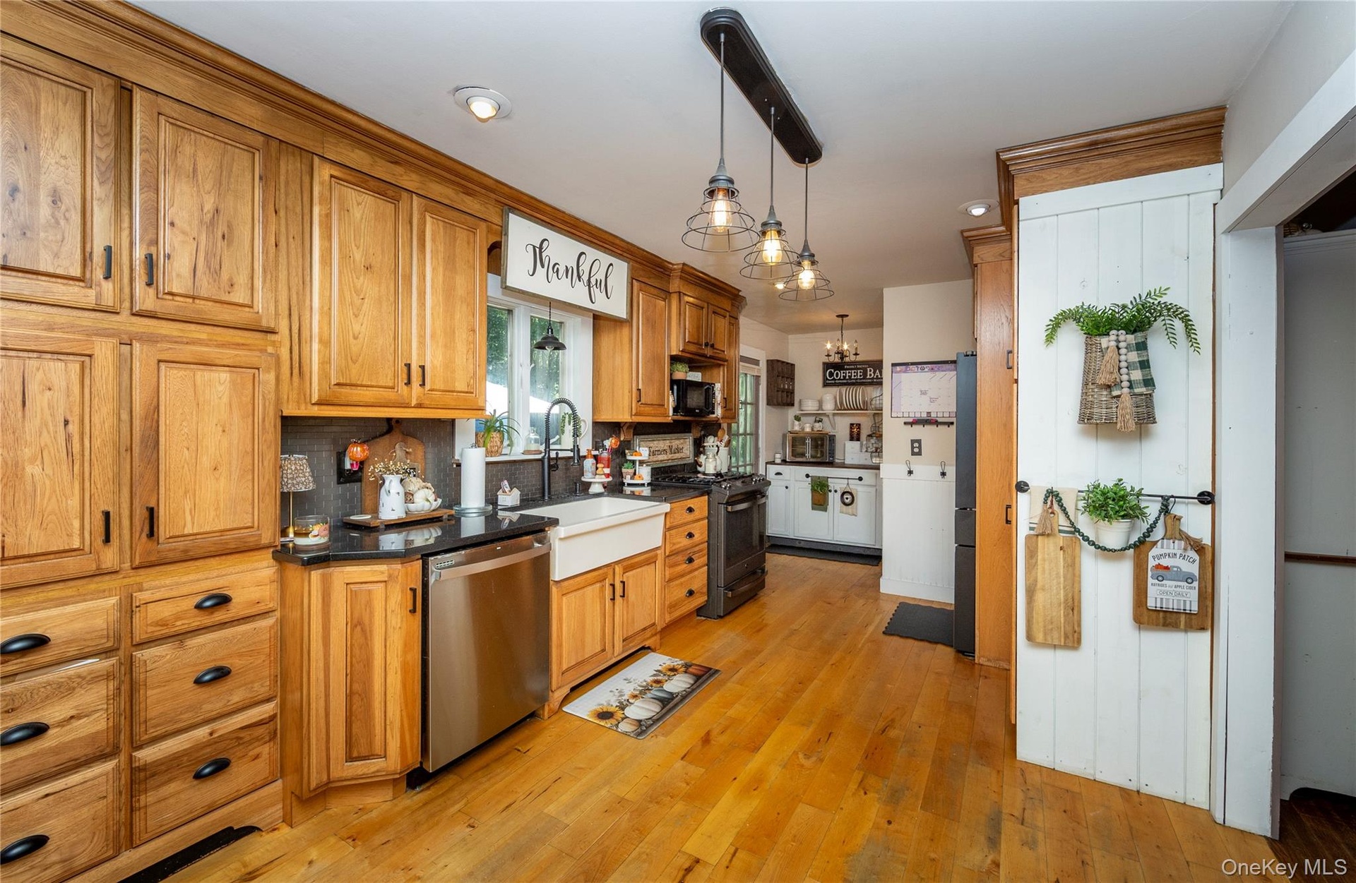 Deep farmhouse sink and abundant cabinetry.