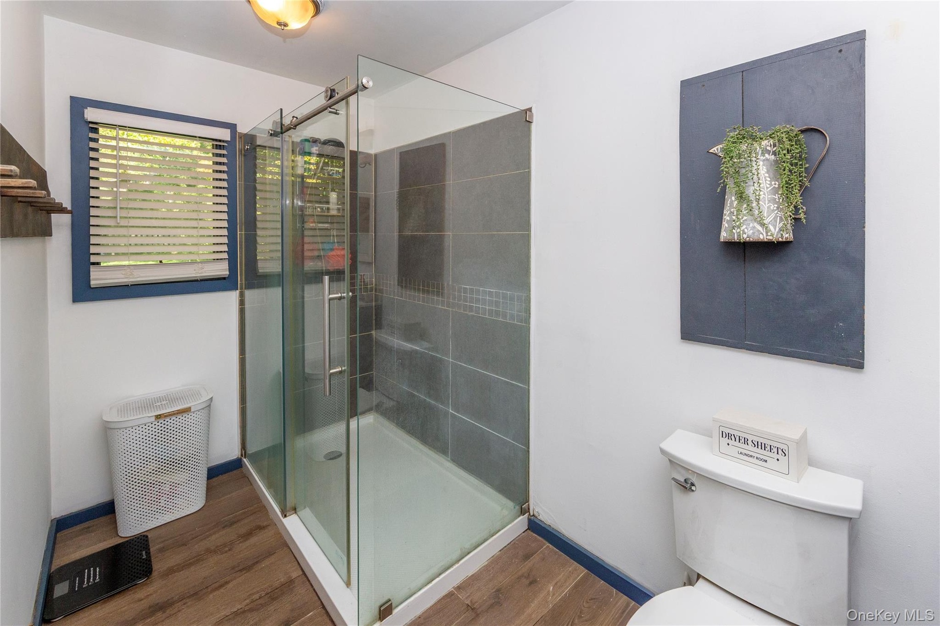 Large walk-in shower with sliding glass shower doors.