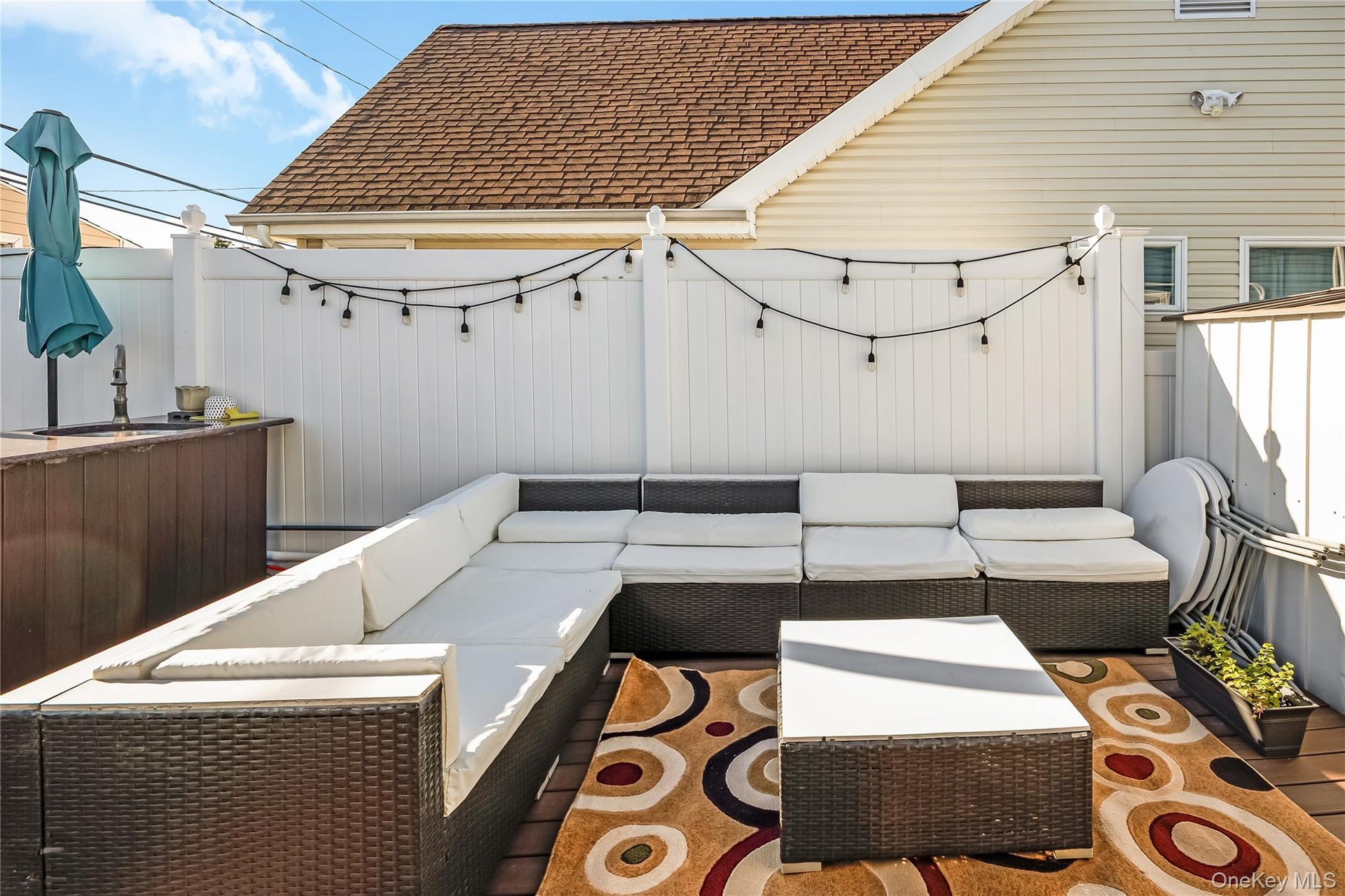 A spacious patio with a well-appointed barbecue area creates an ideal setting for outdoor dining and gatherings.