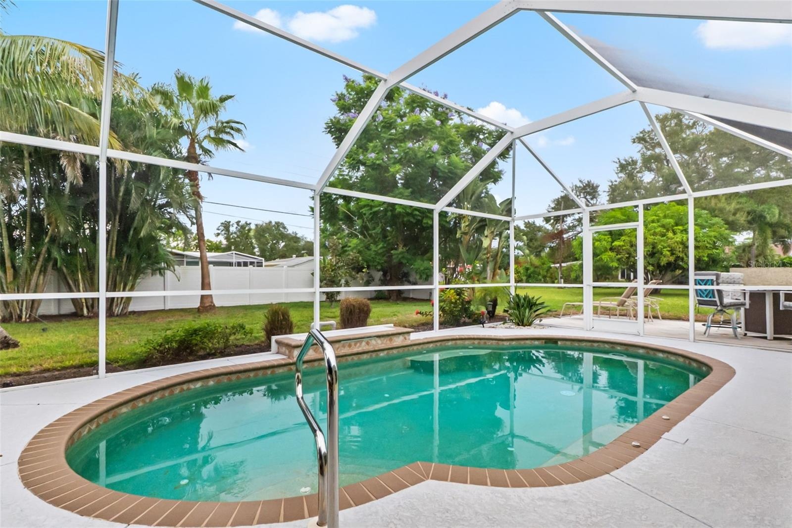 Screened swimming pool with patio space.