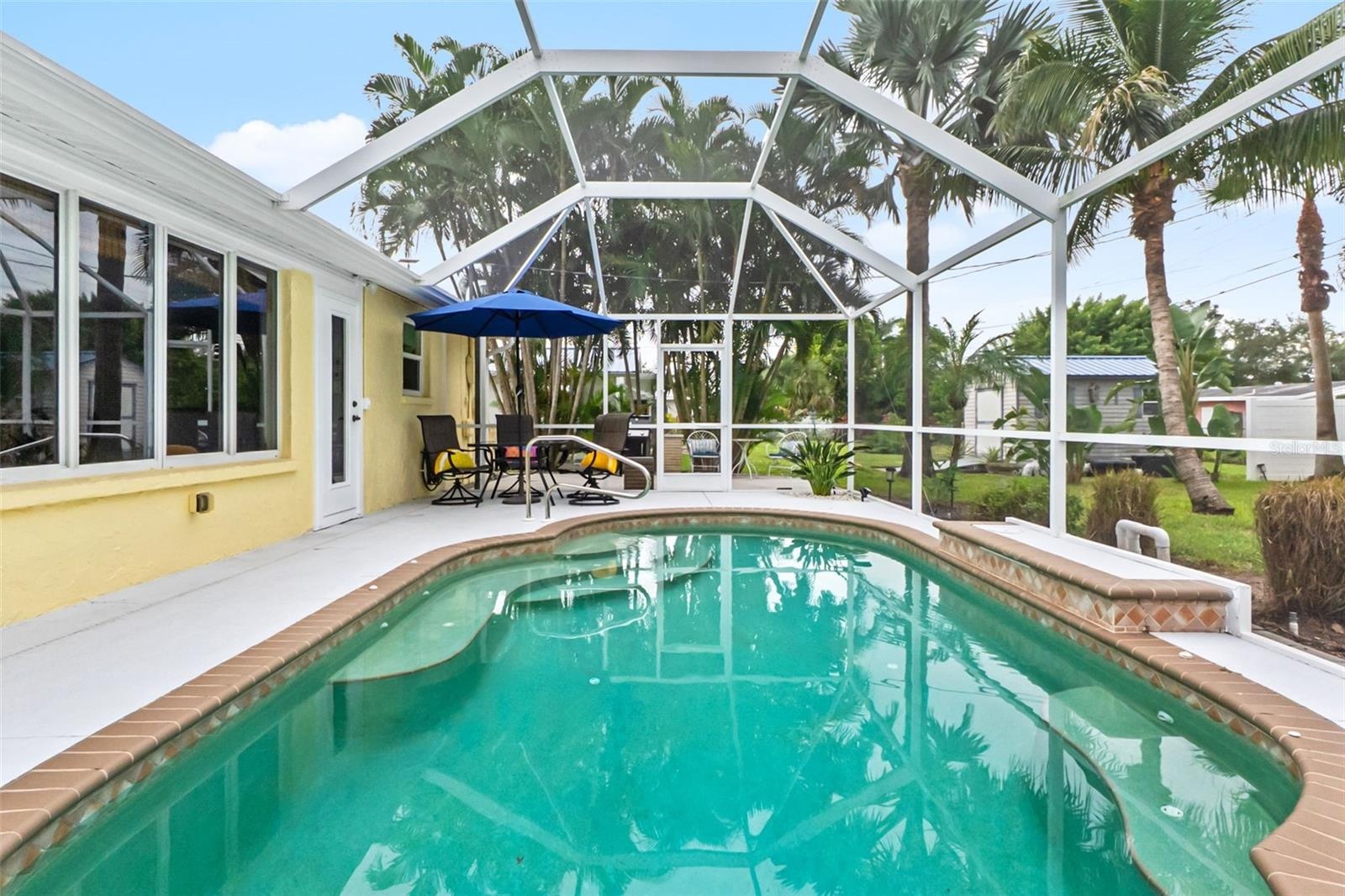 Pool and screened patio along the rear of the home.