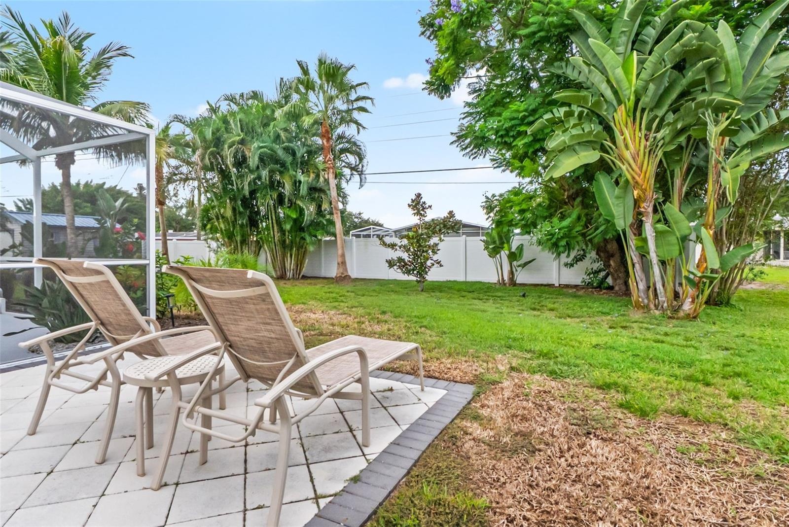 Open patio with lounge seating overlooking the backyard.