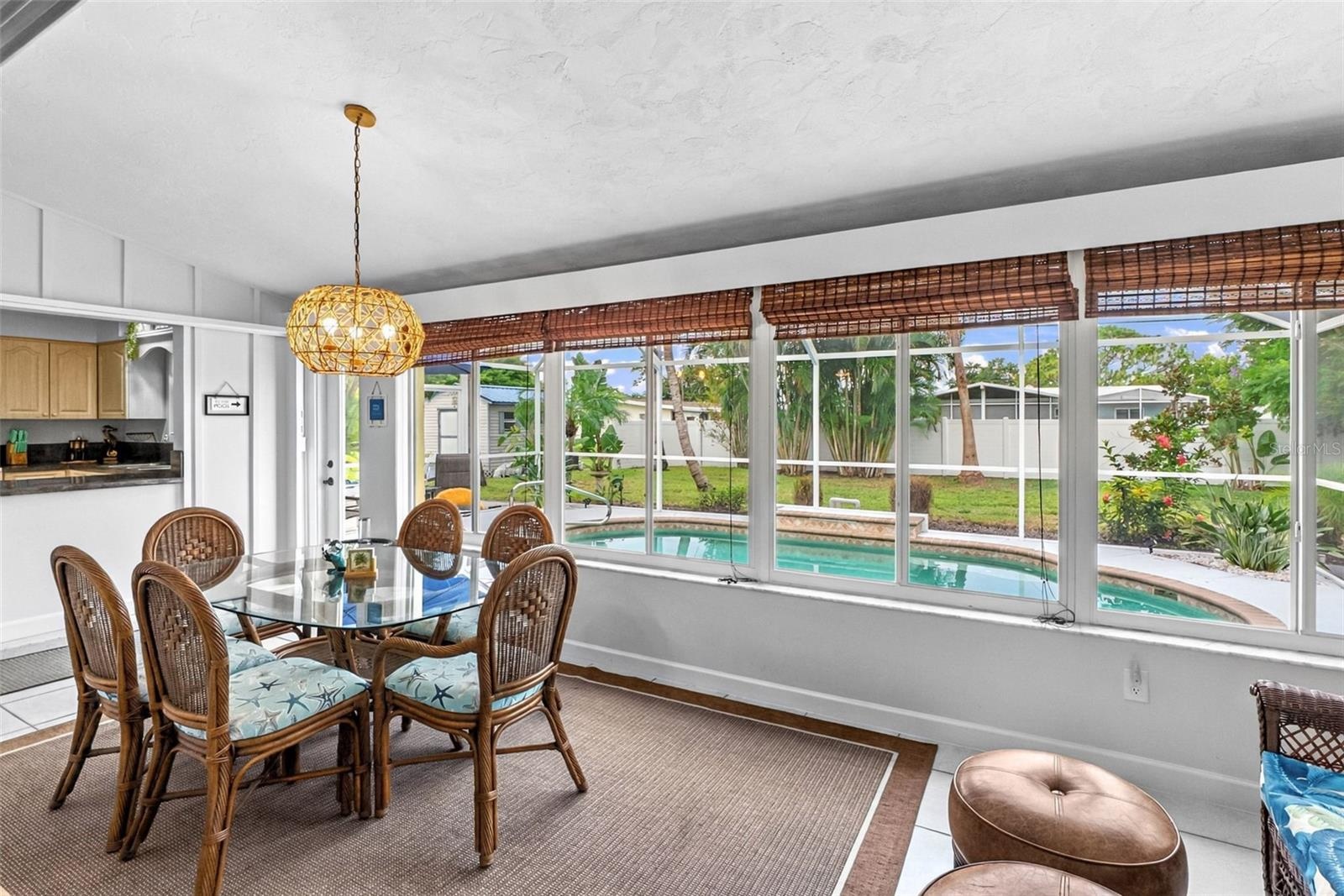 Florida room dining area with pool views.