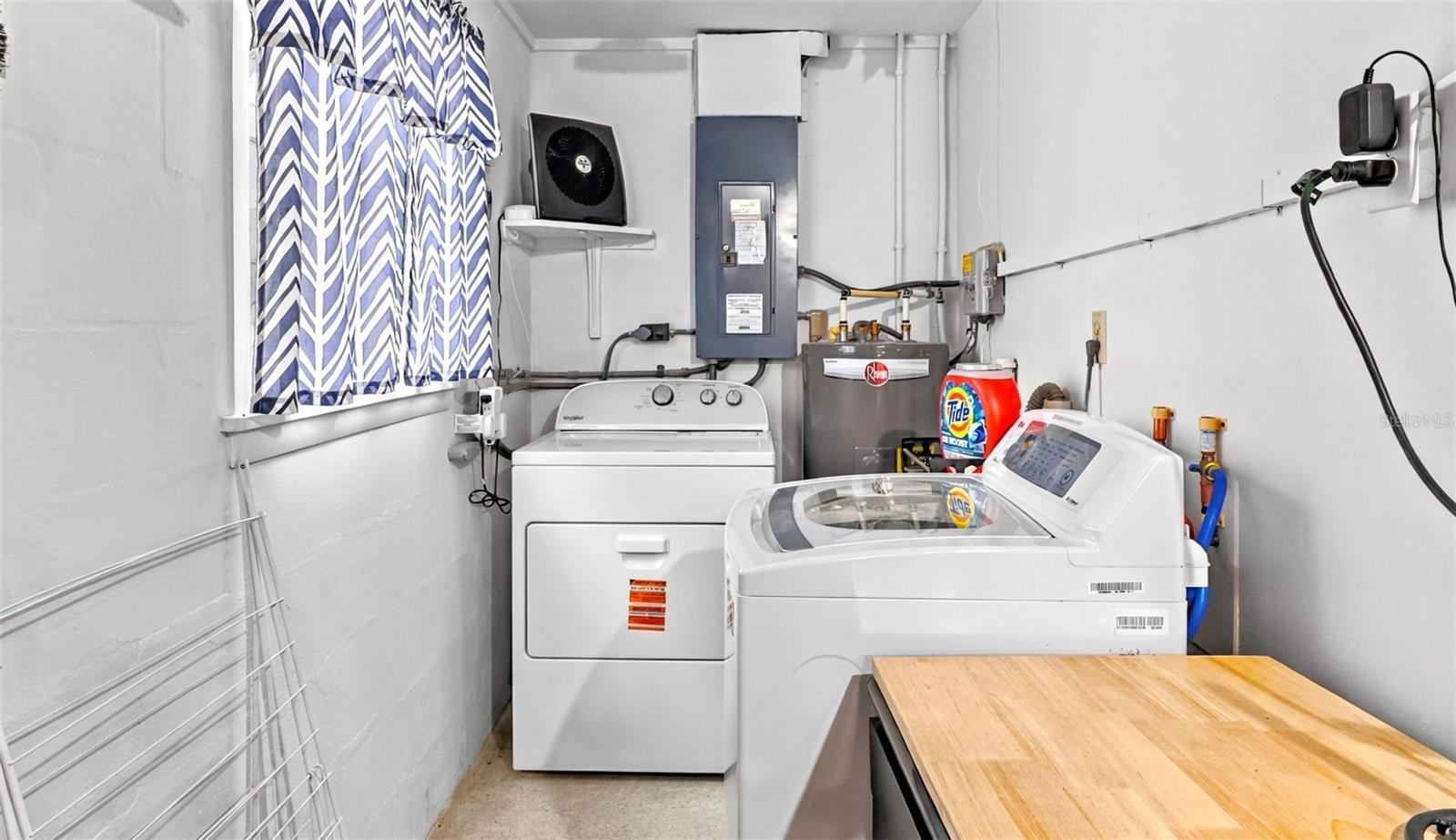 Laundry area with washer, dryer and utility sink.
