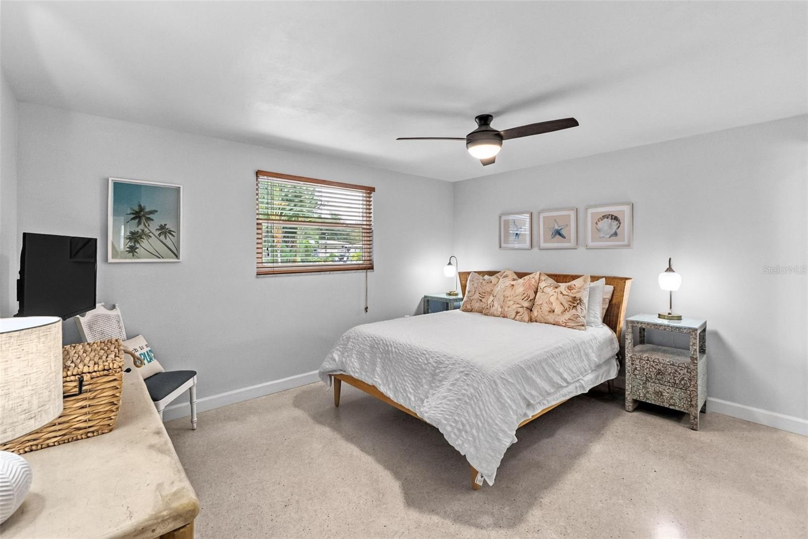 Primary bedroom with coordinating coastal furnishings.