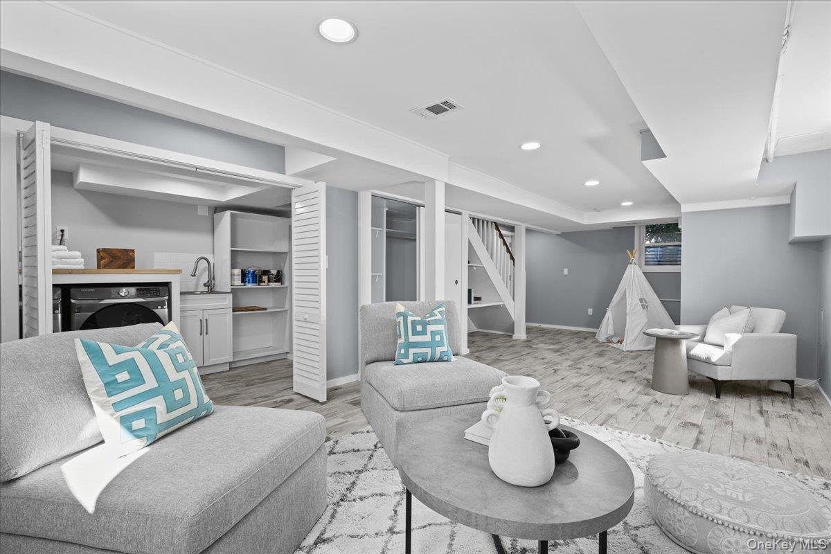 Finished basement space with laundry and access to tandem 2 car garage