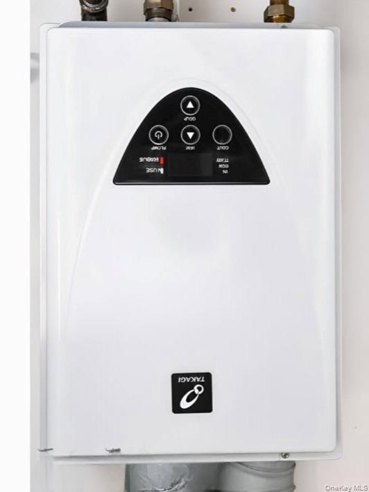 Wall-mounted tankless water heater with digital controls and a white finish