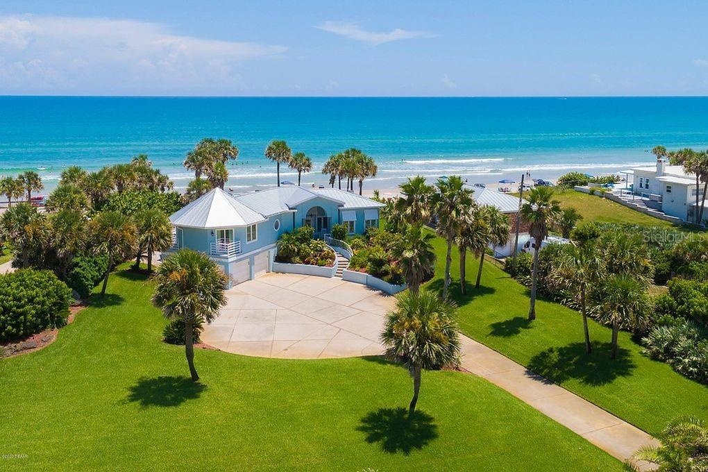 Set on over three-quarters of an acre with approximately 85 feet of ocean frontage, this property offers a generous setback from the road, ample drive