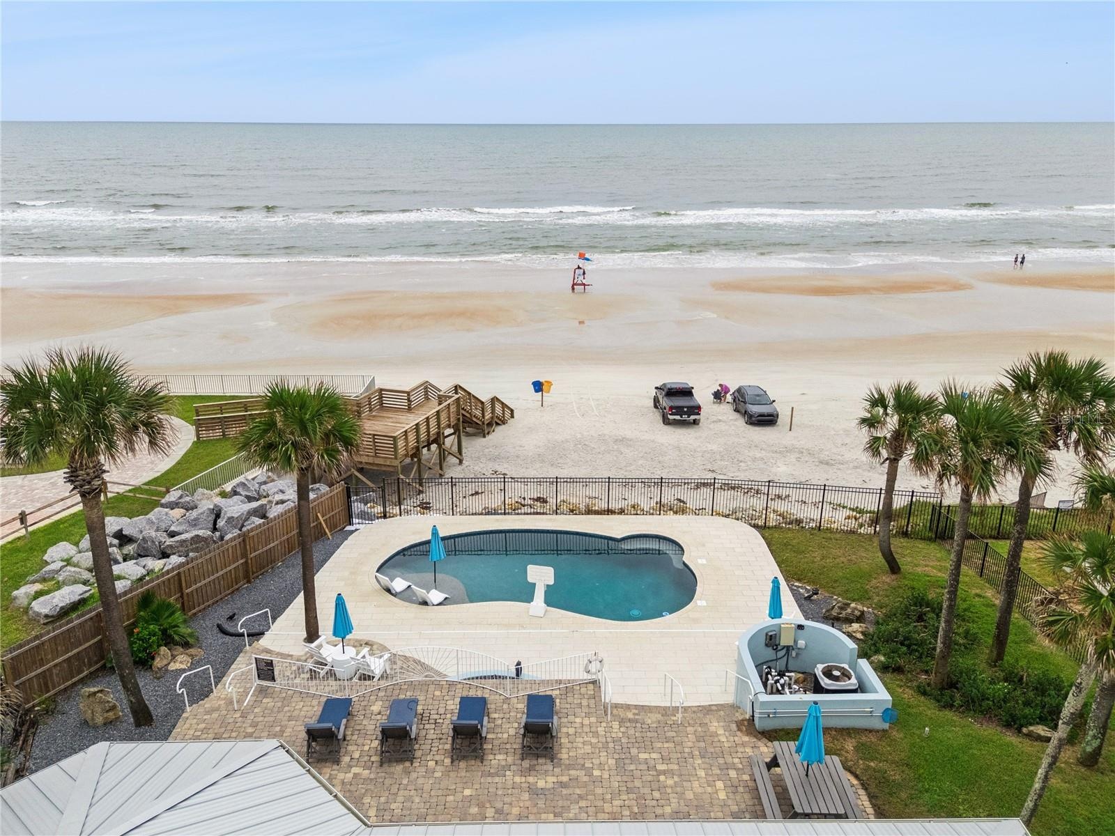 new poolNew oceanfront pool installed in 2024, featuring heating, a sun shelf, bubblers, and a 7-foot-deep end, with expansive patio space and panoram