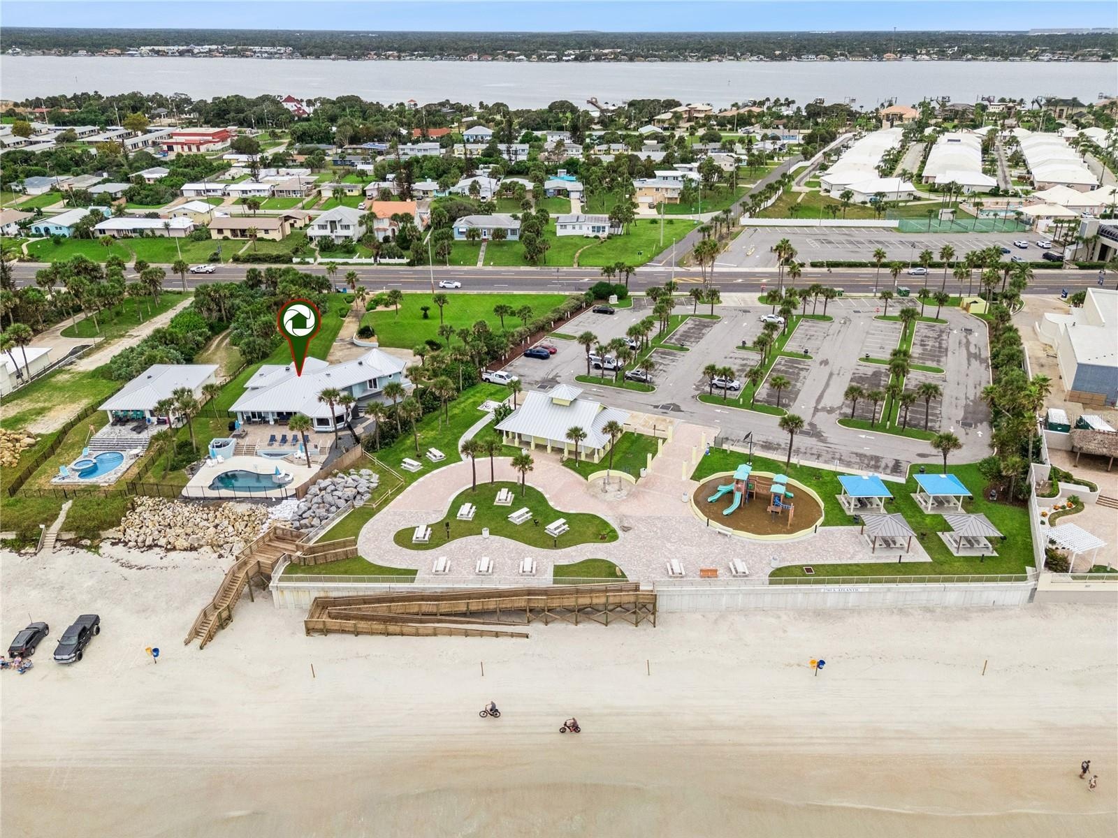 Set on over three-quarters of an acre with approximately 85 feet of ocean frontage, this property offers a generous setback from the road, ample drive