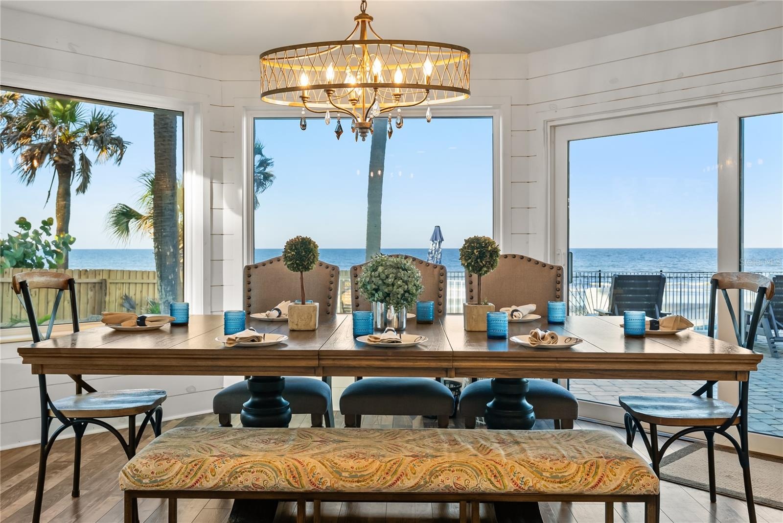 Spacious eat-in kitchen with stainless steel appliances, quartz countertops, breakfast bar seating, and beautiful ocean views—an inviting setting for 
