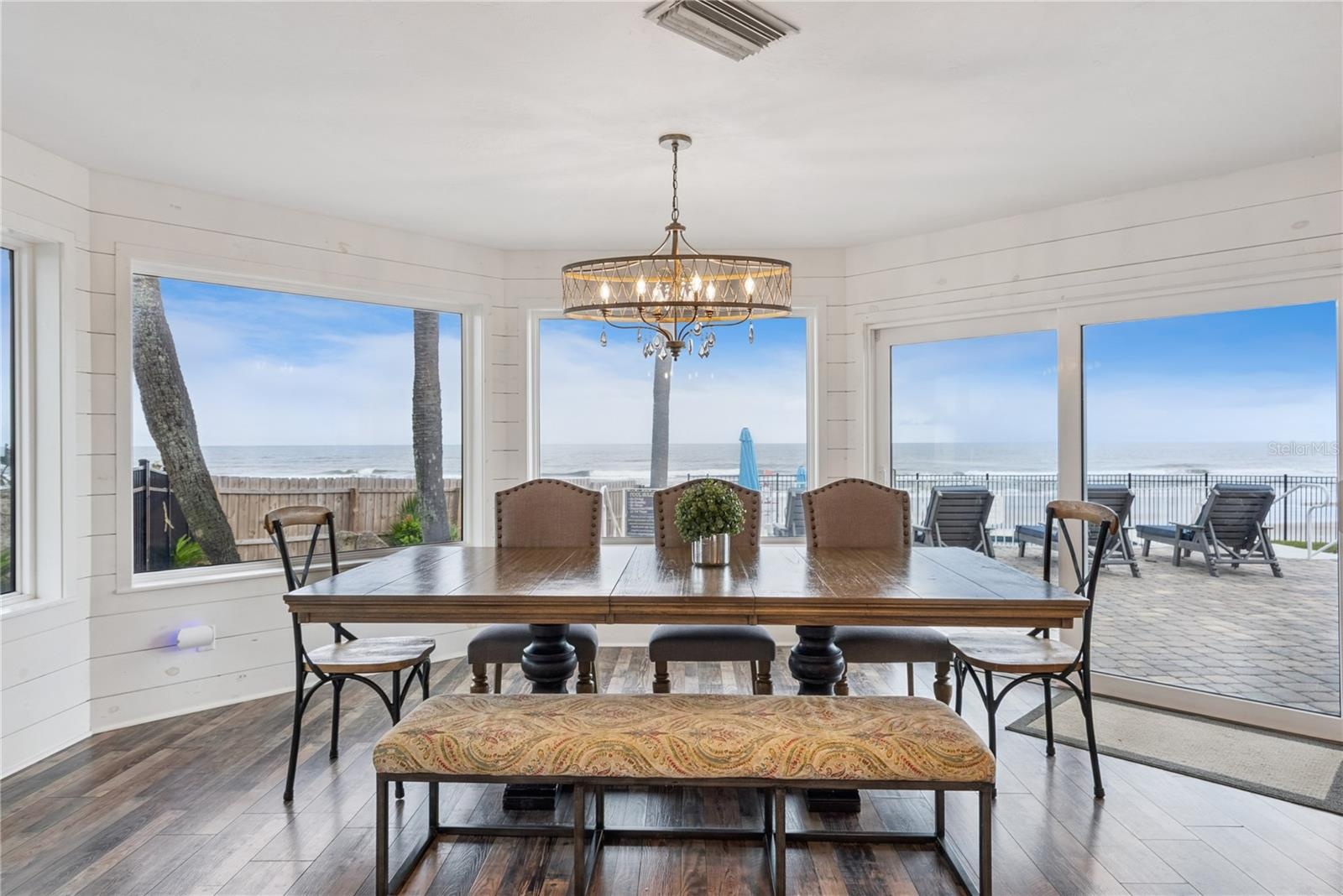 Spacious eat-in kitchen with stainless steel appliances, quartz countertops, breakfast bar seating, and beautiful ocean views—an inviting setting for 