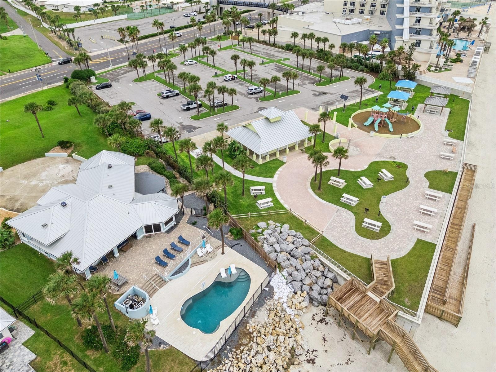 Set on over three-quarters of an acre with approximately 85 feet of ocean frontage, this property offers a generous setback from the road, ample drive