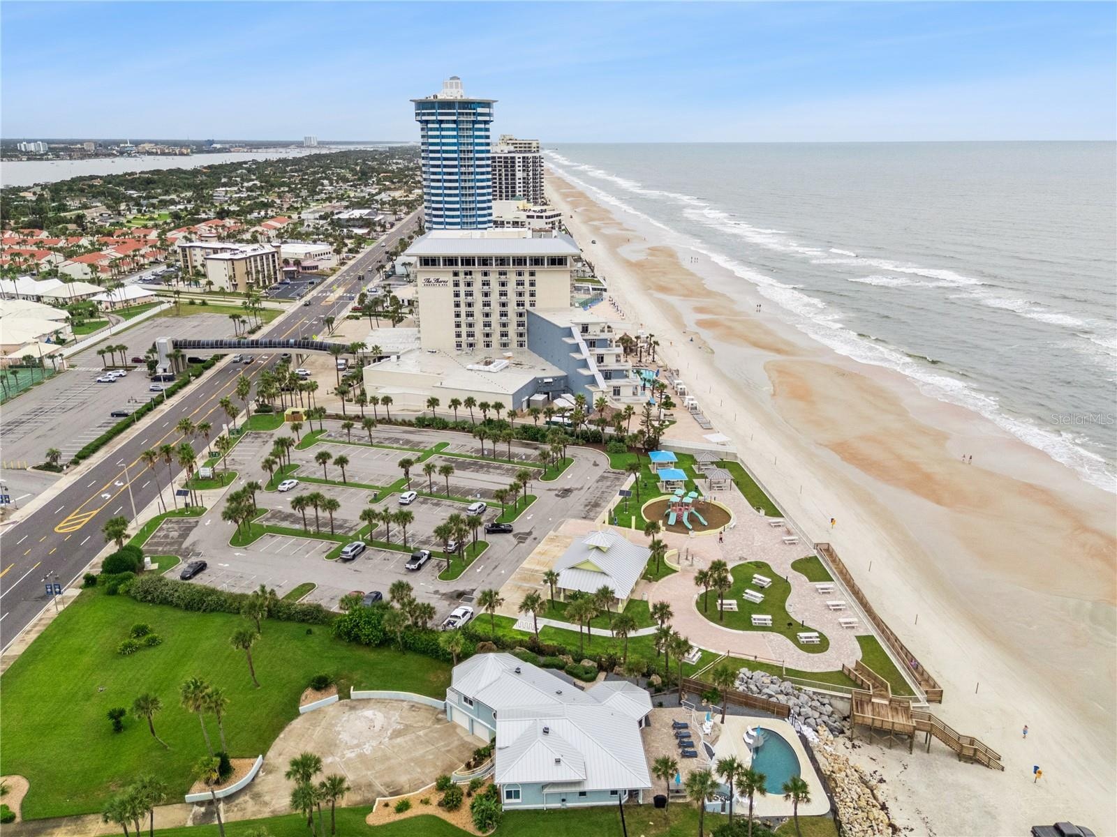 Set on over three-quarters of an acre with approximately 85 feet of ocean frontage, this property offers a generous setback from the road, ample drive
