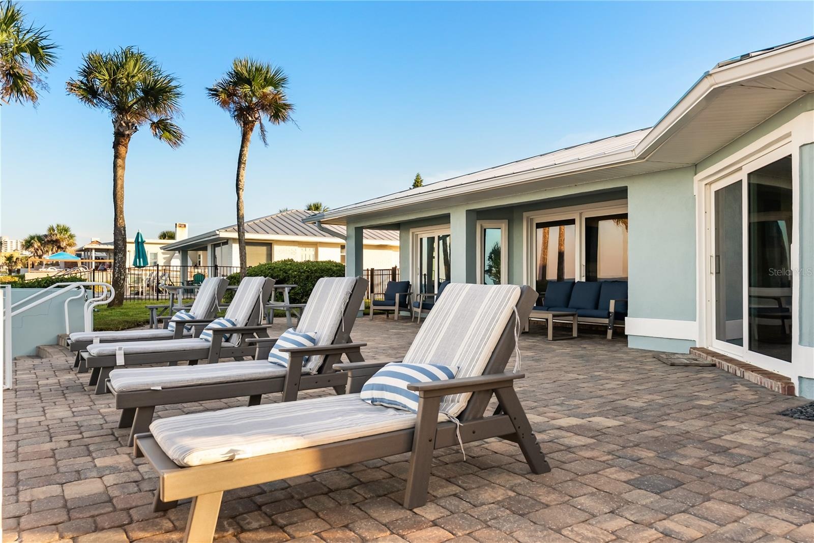 new poolNew oceanfront pool installed in 2024, featuring heating, a sun shelf, bubblers, and a 7-foot-deep end, with expansive patio space and panoram